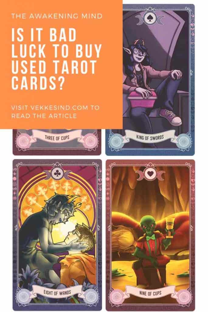 A tarot reader's hands holding a deck of cards near a window with soft natural light