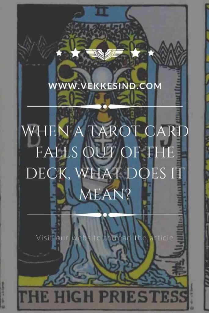 Tarot cards arranged on a surface with one card lying apart, face down