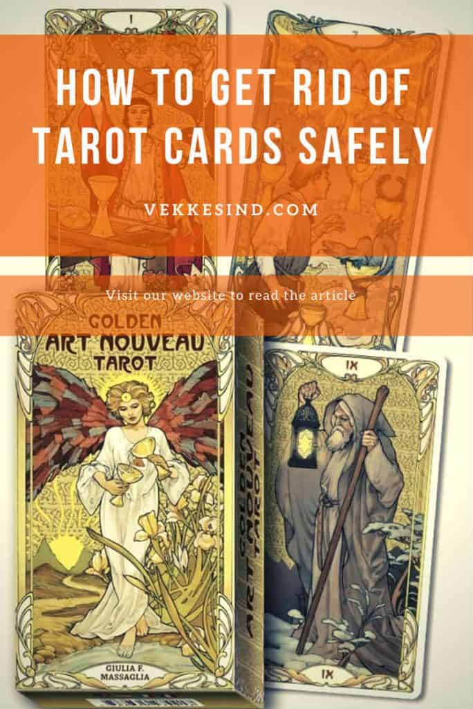 Tarot cards spread on a wooden surface with a candle and crystals nearby