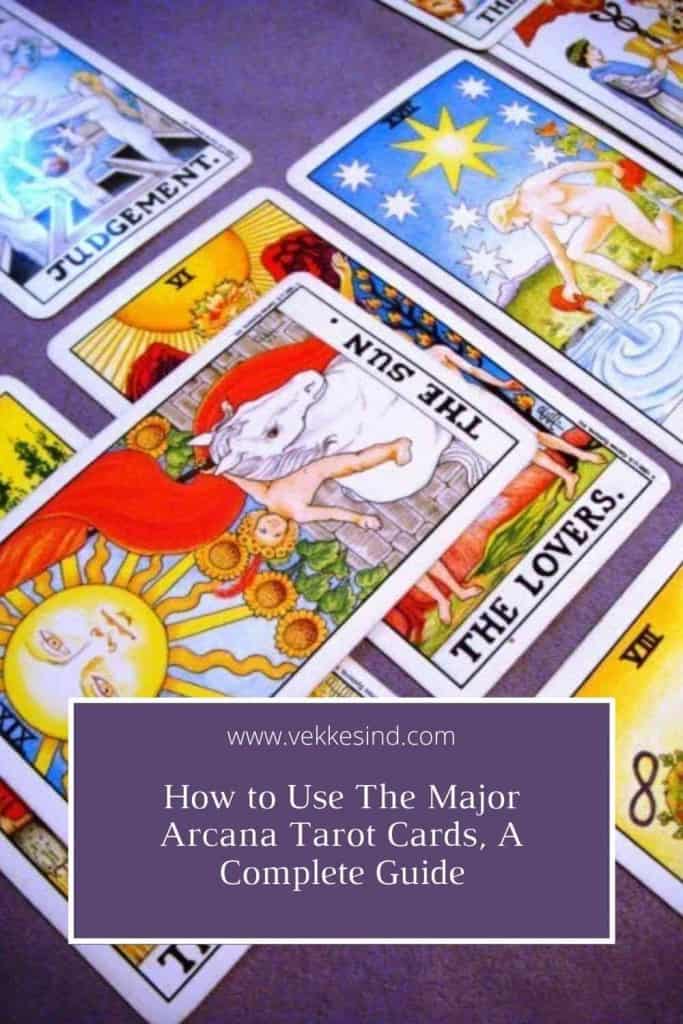 A tarot reader laying out cards on a table, Major Arcana cards facing upright in a spread