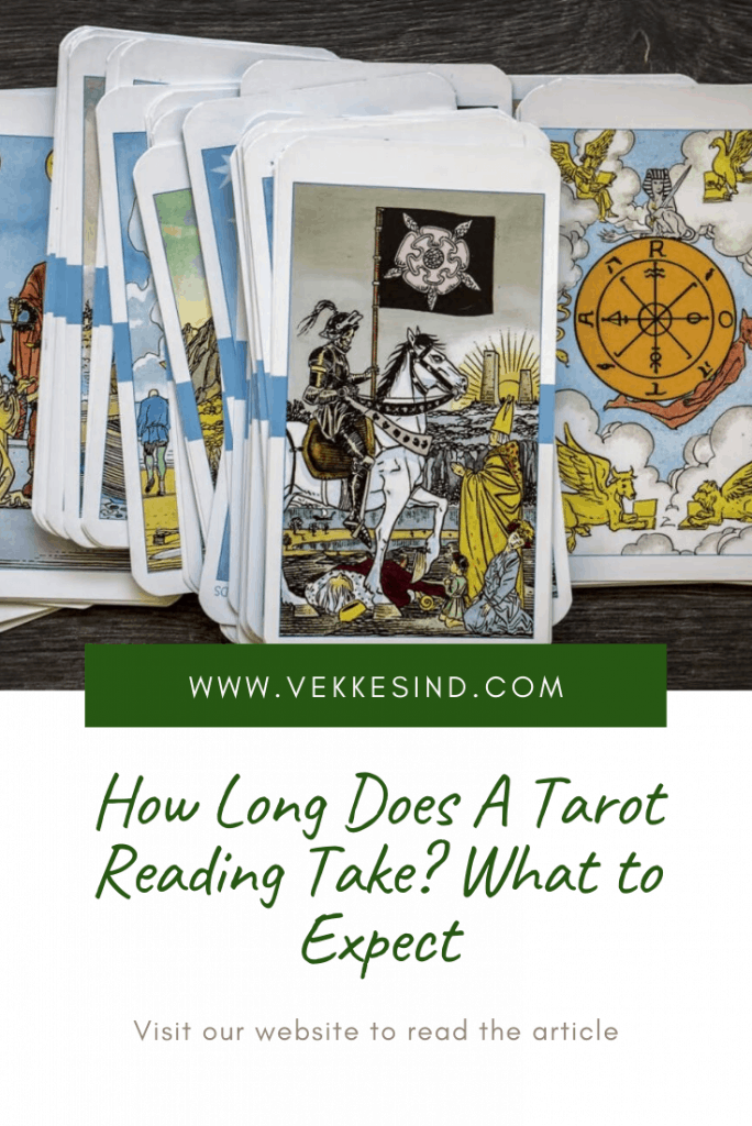 A person reviewing tarot cards at a table, reflecting on a recent reading session