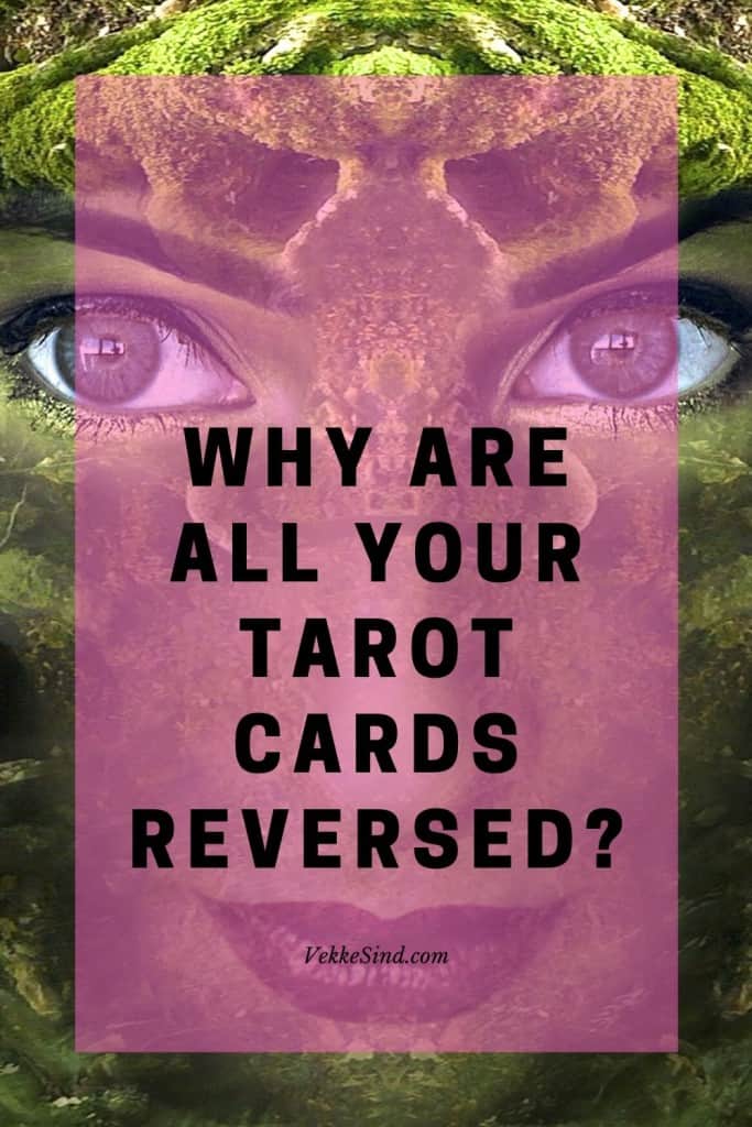 A full tarot spread laid out on a cloth surface with all cards facing reversed position