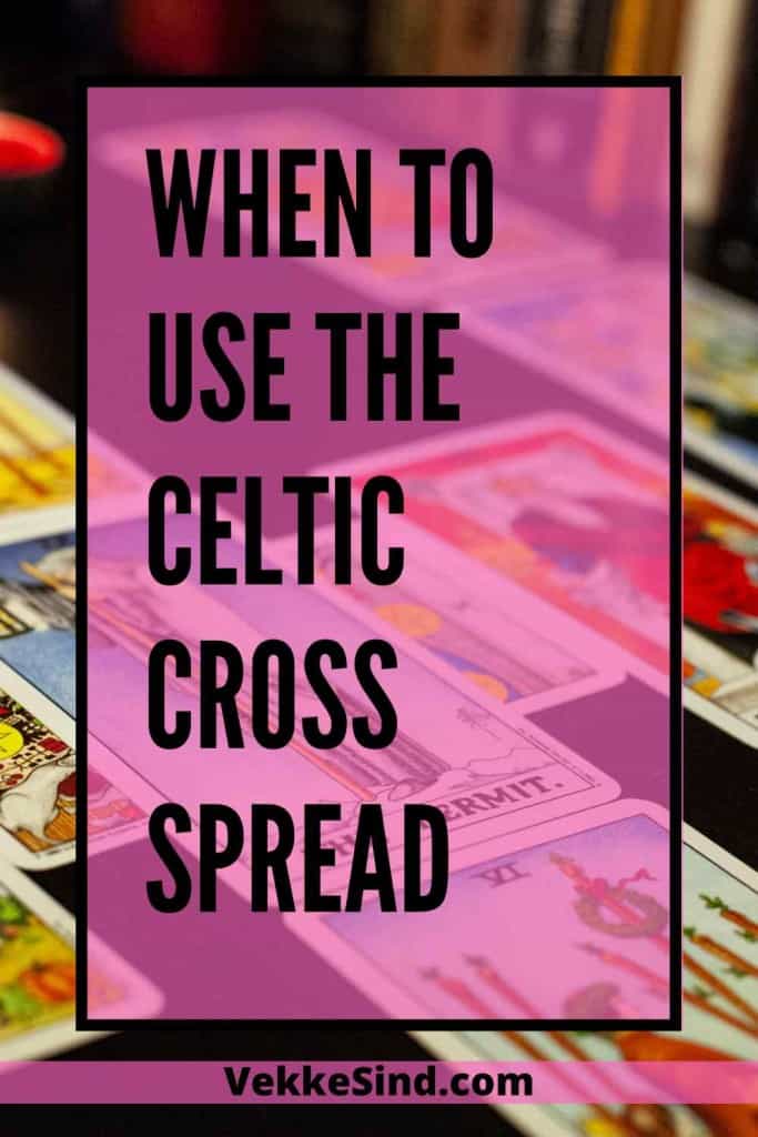 A tarot reader laying out the Celtic Cross spread on a wooden table