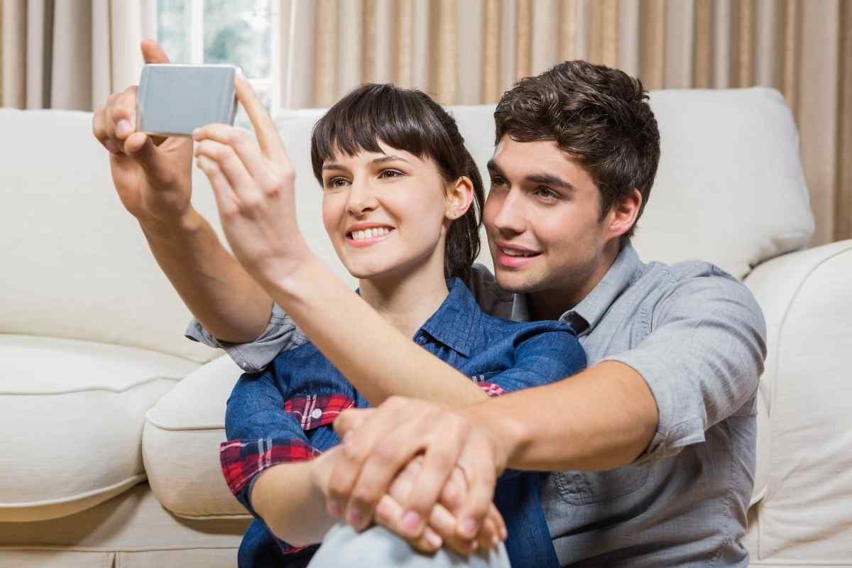 Man sending a confident, unhurried message on his phone, warm indoor setting, settled energy