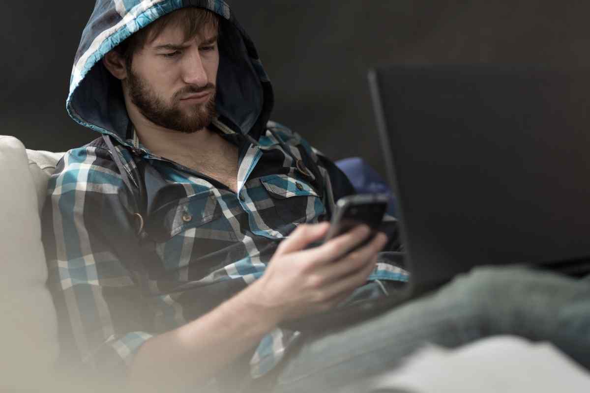 Woman reading a message with calm composure, soft indoor light, settled and unbothered
