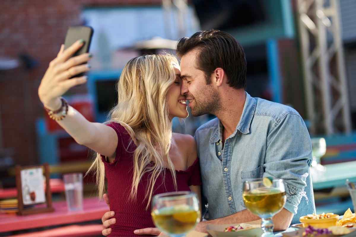 A woman texting with warmth and genuine care, soft and present in her expression