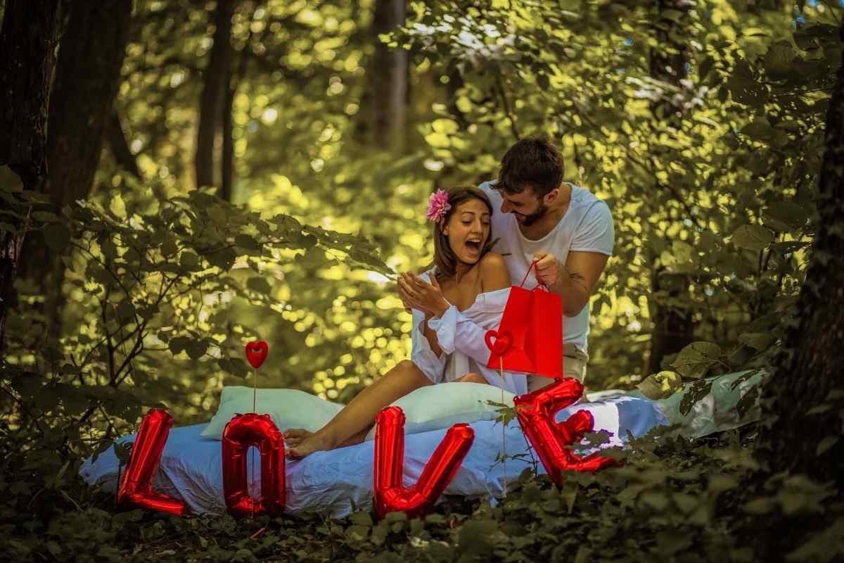 A couple sharing a warm and tender moment outdoors, reflecting the nurturing and devoted energy associated with Cancer and Leo birthdays in July