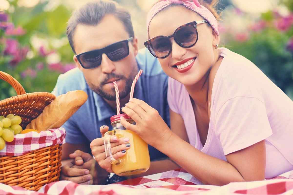 A couple sharing a relaxed outdoor moment, showing the easy and grounded connection that draws a Taurus woman in