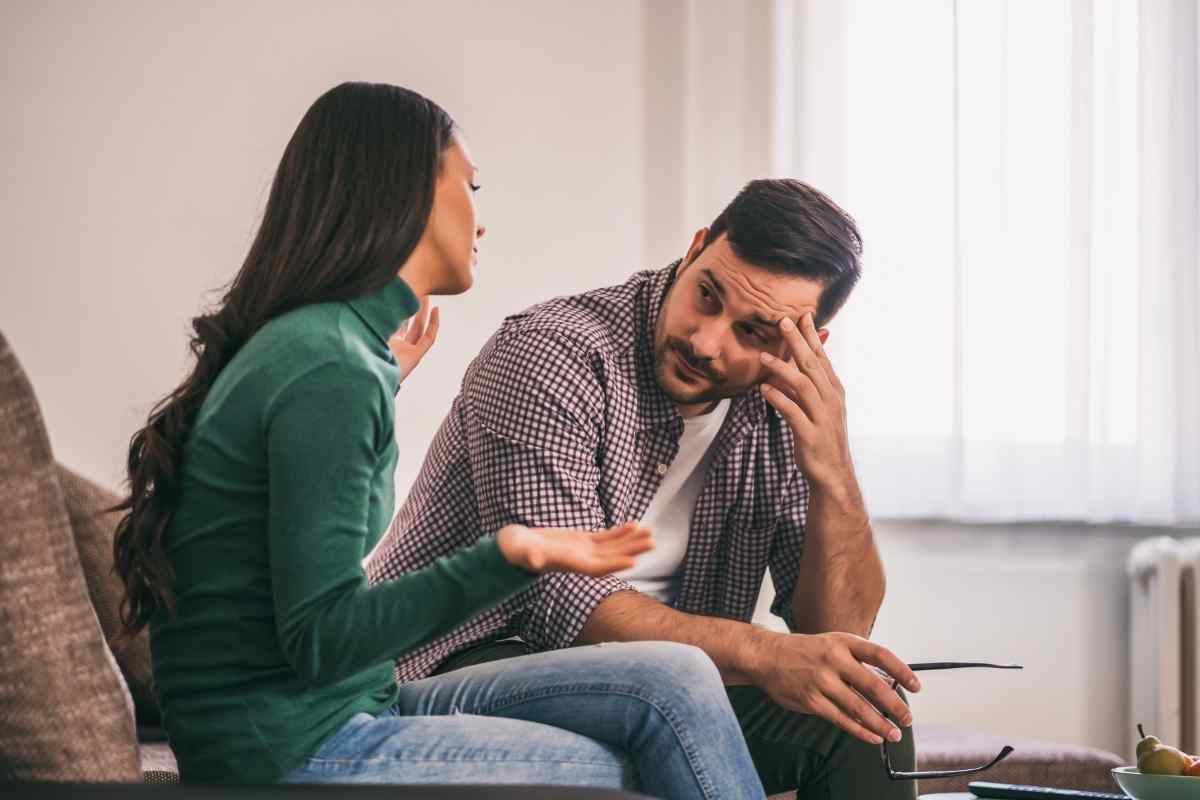 A couple reconnecting with quiet mutual honesty, sitting close but giving each other full space