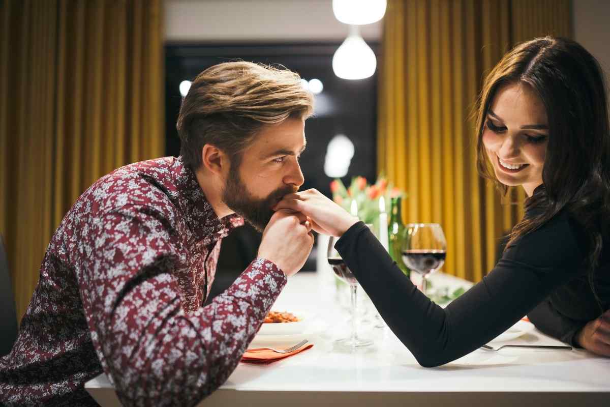 A man checking his phone with a blank expression, emotionally absent from the conversation