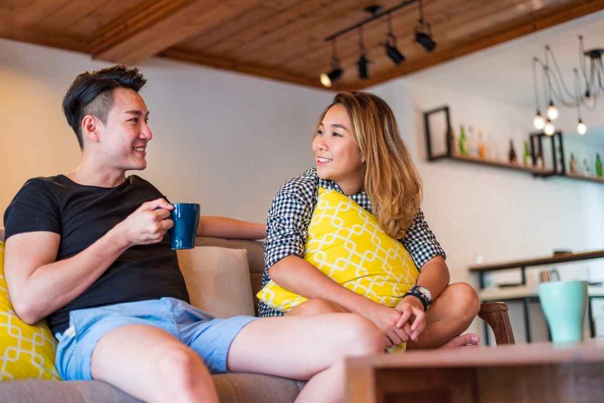 A couple sharing a warm, engaged moment together, both fully present and expressive, reflecting the solar energy and mutual openness that a Leo man needs to feel genuinely seen and wanted in intimate connection