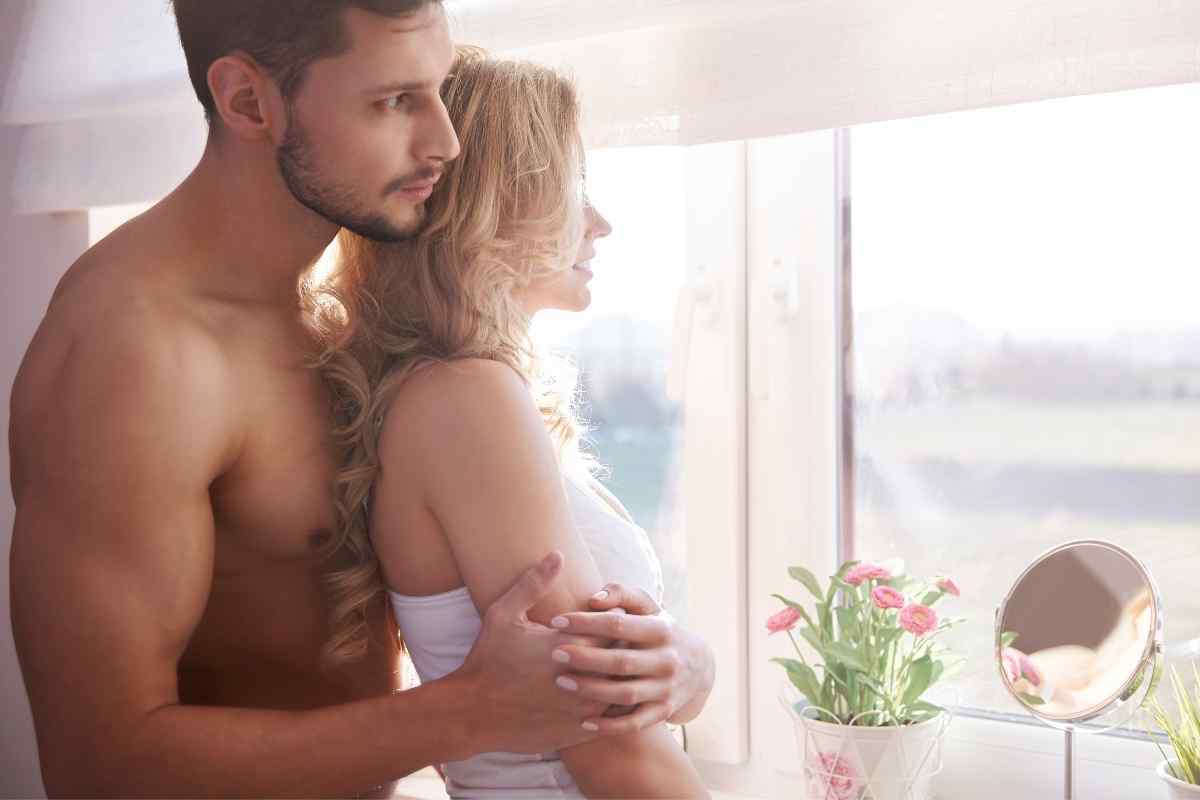 A couple sharing a warm, candlelit intimate moment that reflects the Libra man's love of balance and romantic give-and-take