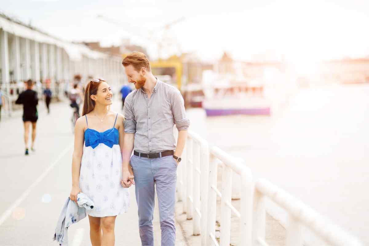 A confident, energetic woman making deliberate physical contact with someone she is interested in, capturing the natural warmth of an Aries woman's flirting