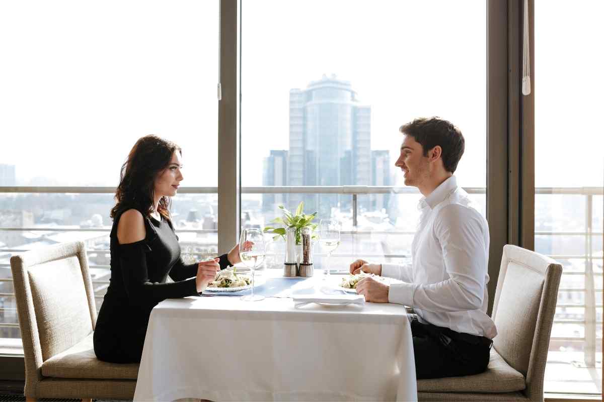 Two people exchanging a brief, composed greeting in a neutral public setting, both carrying themselves with quiet dignity