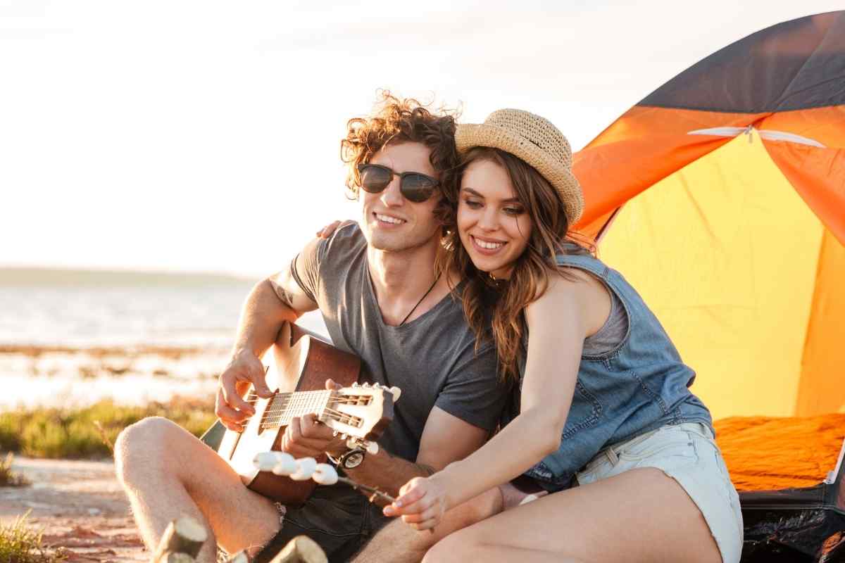 An Aries woman laughing openly with someone, energetic and fully present in a relaxed, outdoor setting