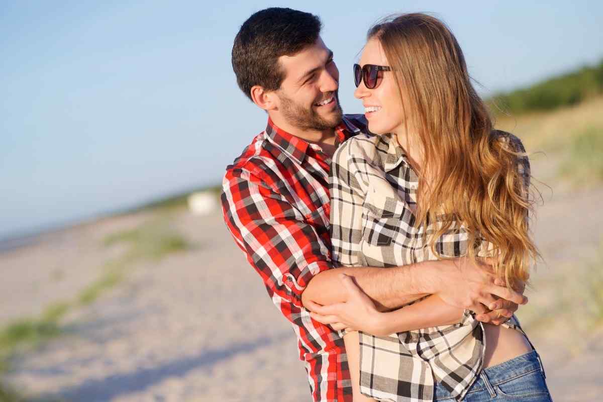 An Aries woman standing close to someone, confident and protective in her body language, fully engaged
