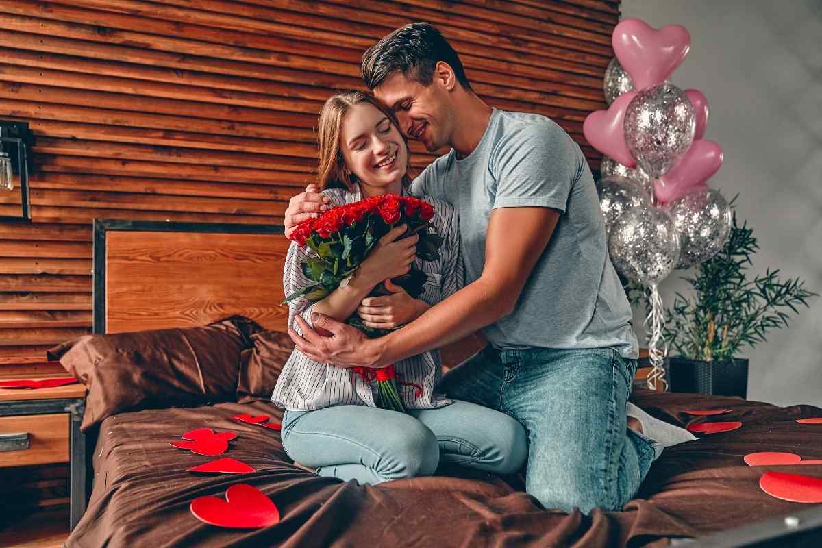 A couple sitting on a couch, one person listening closely while the other speaks, representing the emotional openness and attentiveness that a Pisces man needs to feel loved