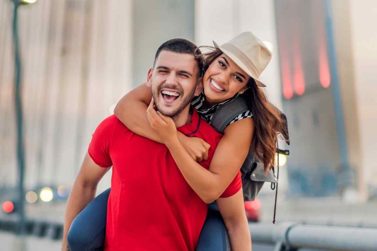 A couple sharing an easy, unguarded moment outdoors in open countryside