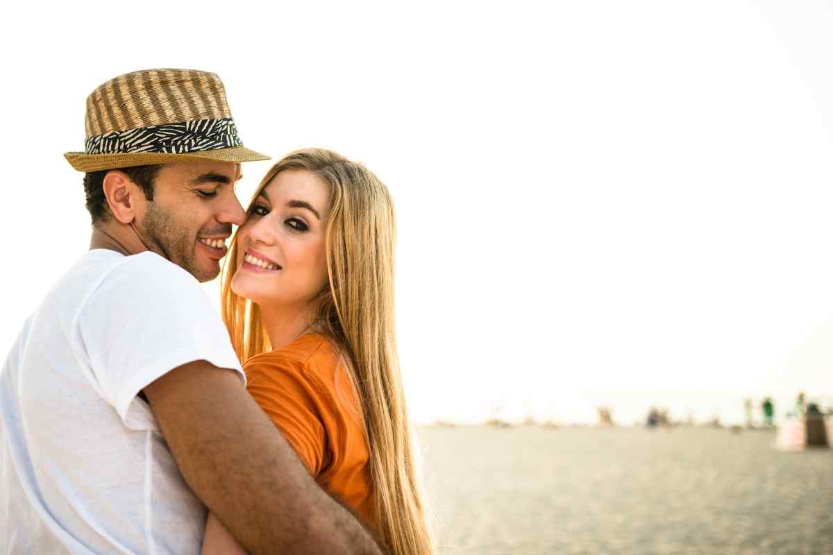 Couple sitting apart with visible emotional distance, illustrating the signs of a Leo woman withdrawing from a relationship