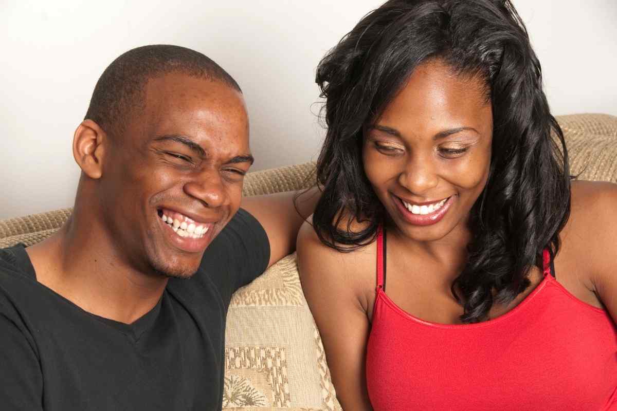 A couple sitting at a table together but not speaking, both looking elsewhere