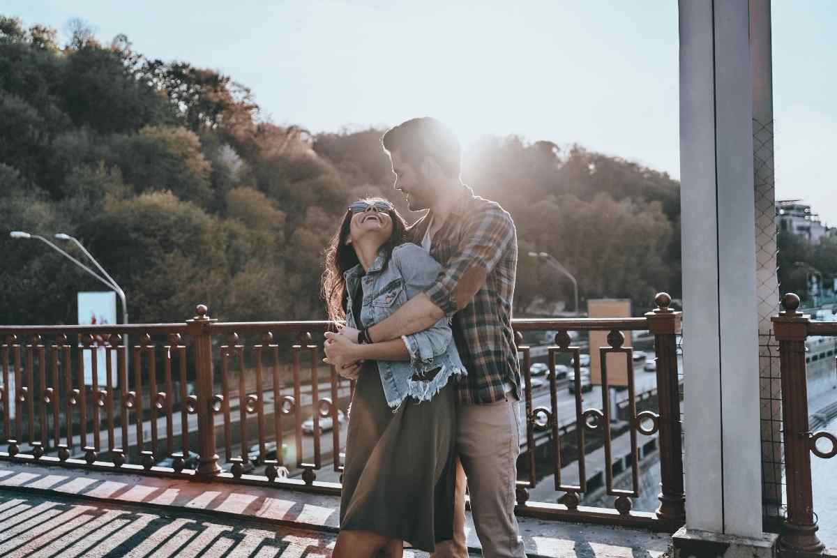 A Leo man and Sagittarius woman together outdoors, capturing the adventurous warmth and mutual enthusiasm that makes this pairing genuinely alive over time