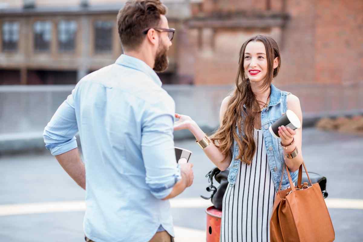 Couple sitting across from each other at a table having a clear, composed conversation