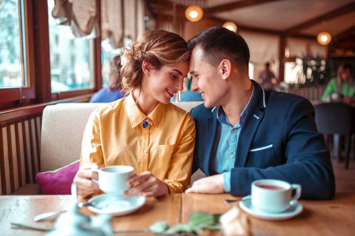 Man sitting thoughtfully at a cafe window processing complex feelings