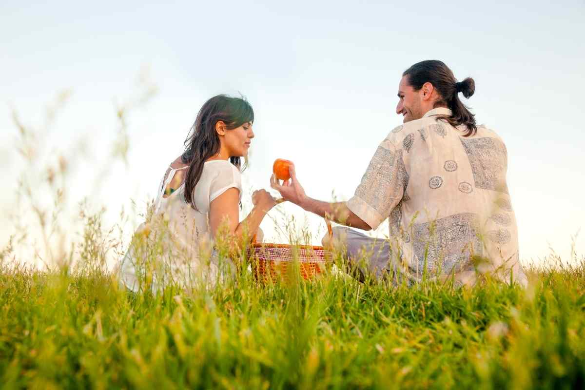 Couple sitting quietly side by side, comfortable with the silence between them, no tension visible