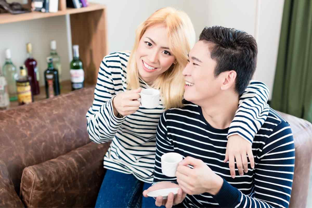 Two people having a quiet, calm conversation at a table, both listening and open
