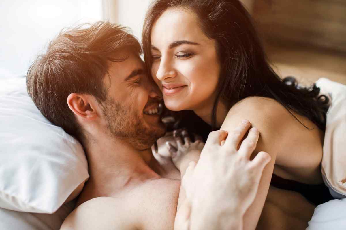 A couple sitting close together in a warm, well-furnished home environment, sharing a comfortable and grounded moment