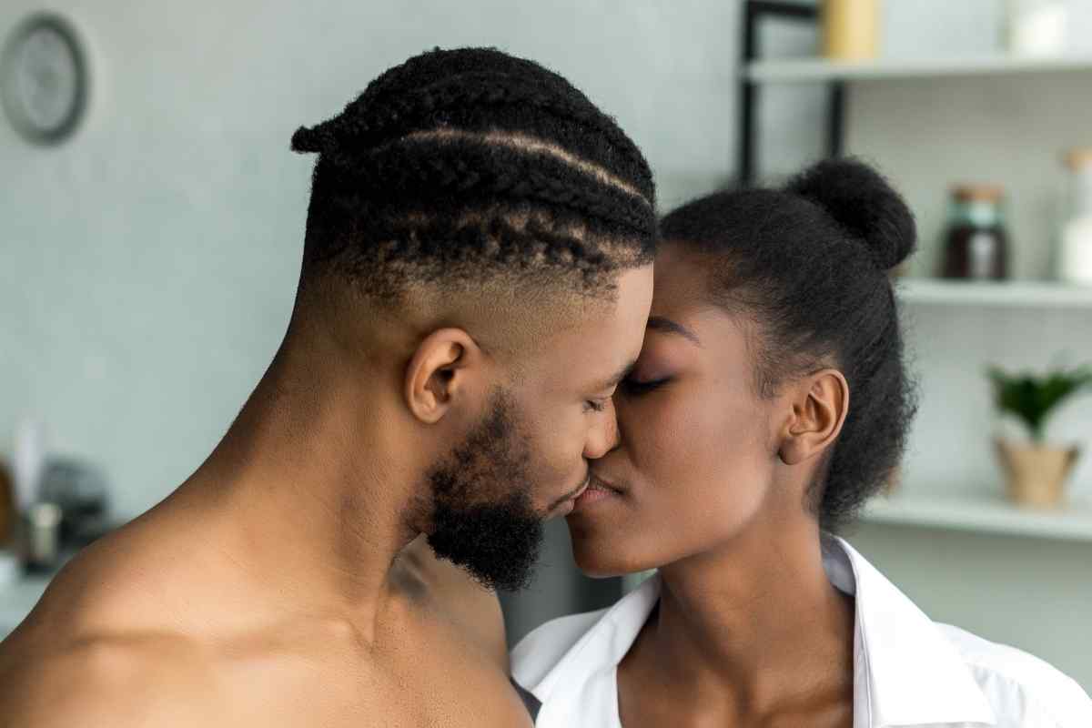 A couple in a relaxed, intimate moment, connected through gentle and attentive physical presence