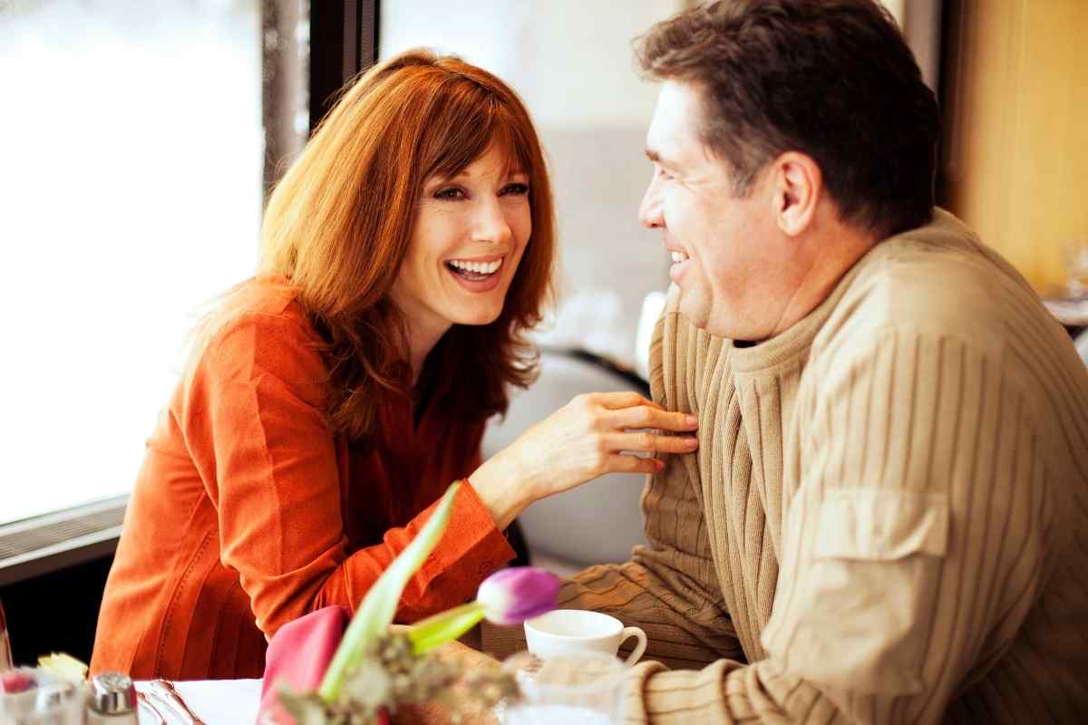 A couple in calm, focused conversation over dinner, evaluating the connection between them
