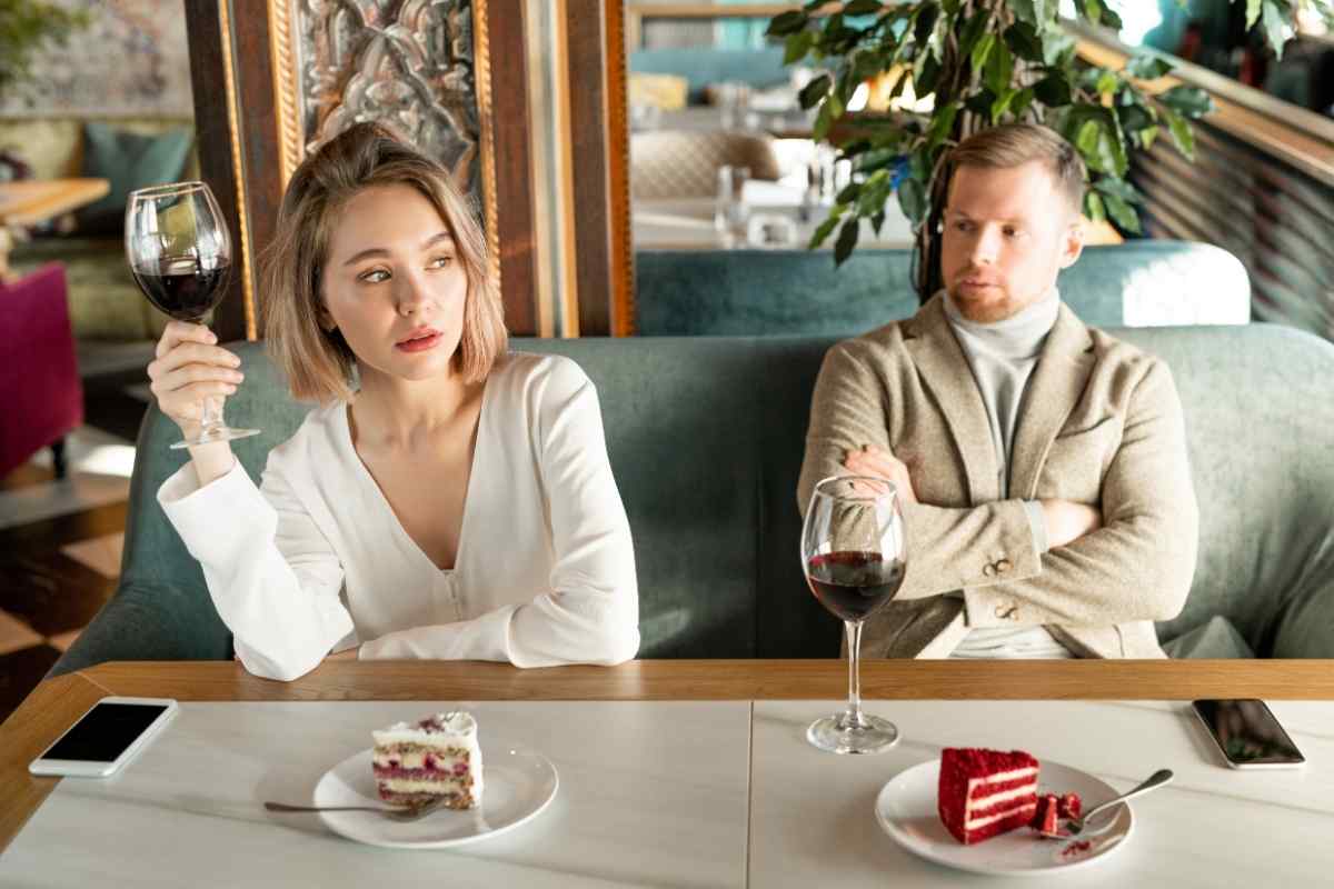A couple with visible tension, one partner looking distracted and the other appearing uncertain