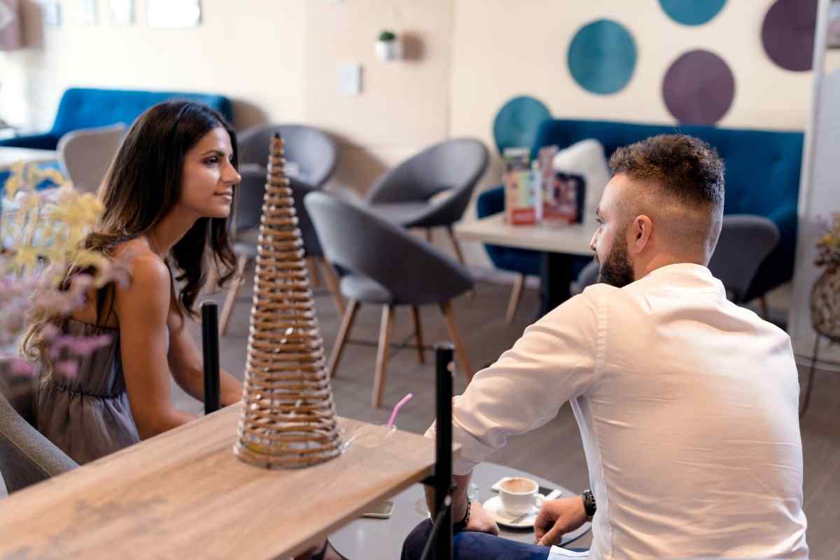 A couple with evident emotional distance, one partner closed off and looking away from the other