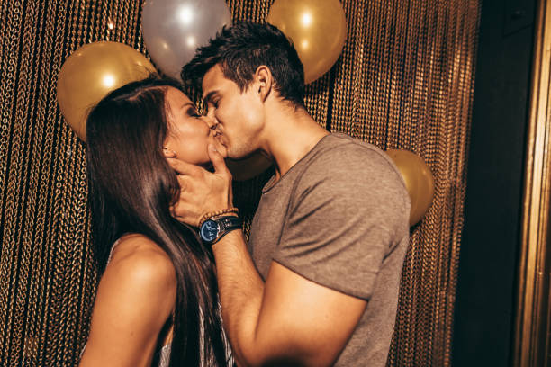 An intimate couple connecting through a slow, meaningful kiss
