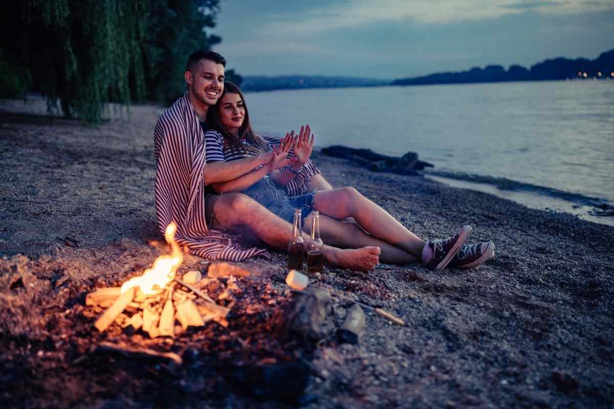A couple sharing a soft, unhurried kiss in a warm setting