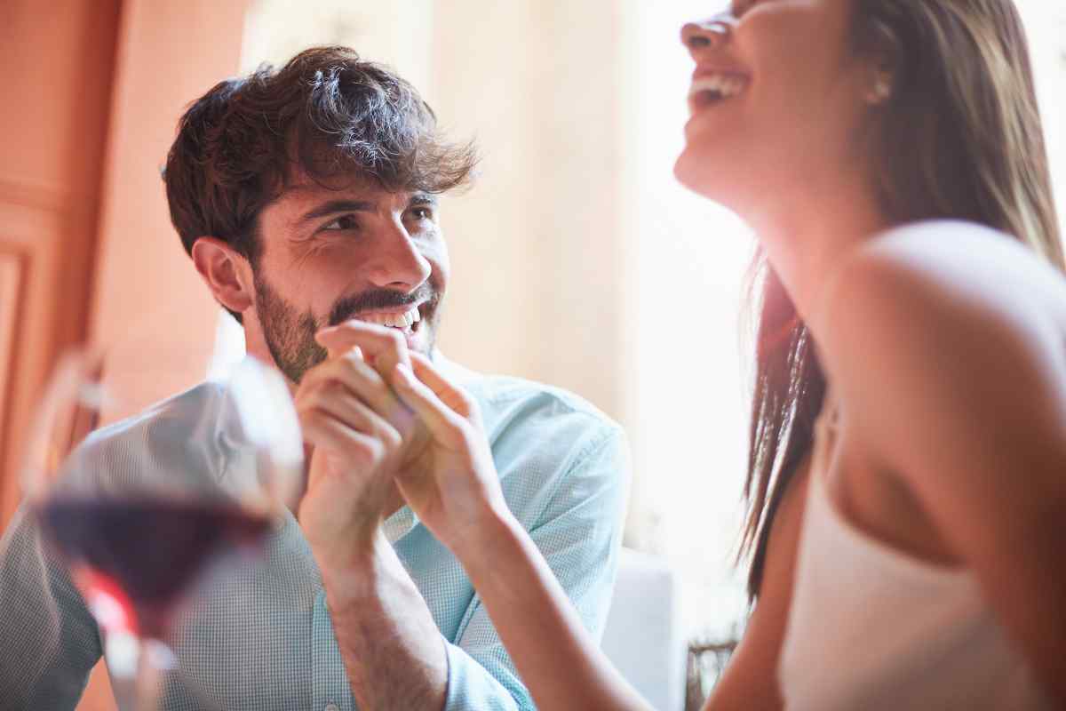 A couple sharing an intensely focused, close kiss in a private setting