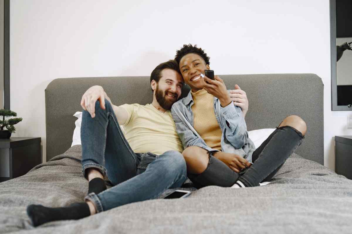 A couple in a relaxed, playful moment of physical closeness