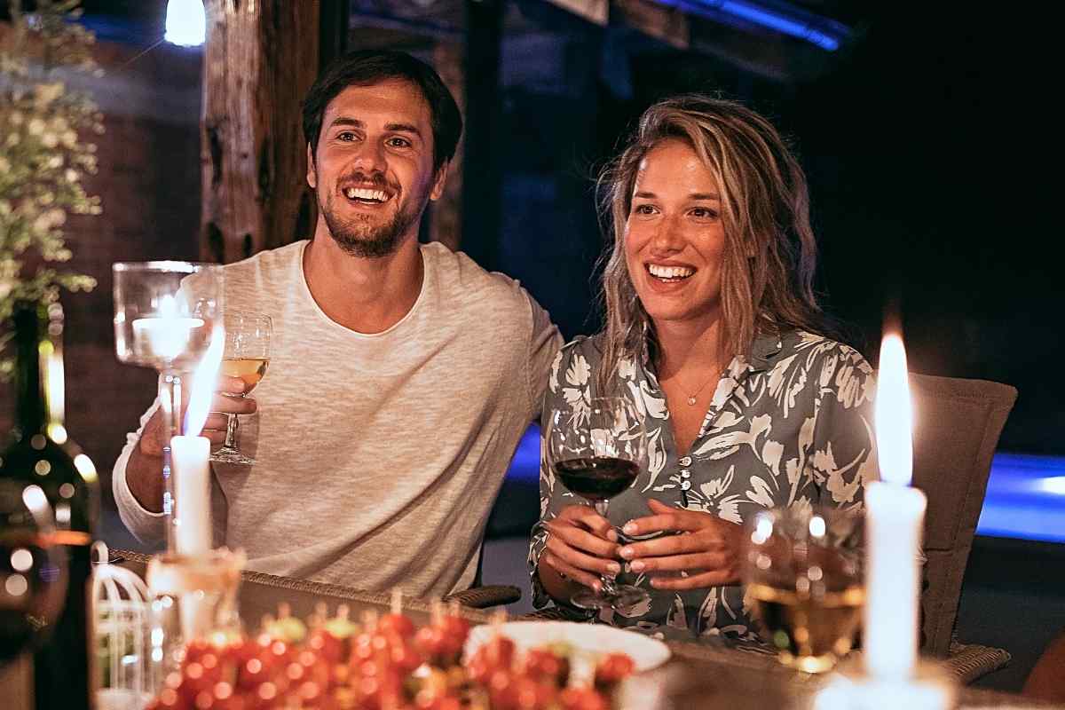 A couple walking together in a relaxed outdoor setting in the evening
