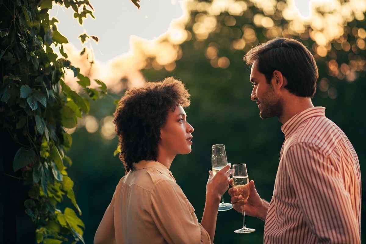 A man and woman laughing together in a relaxed, comfortable setting after a good conversation