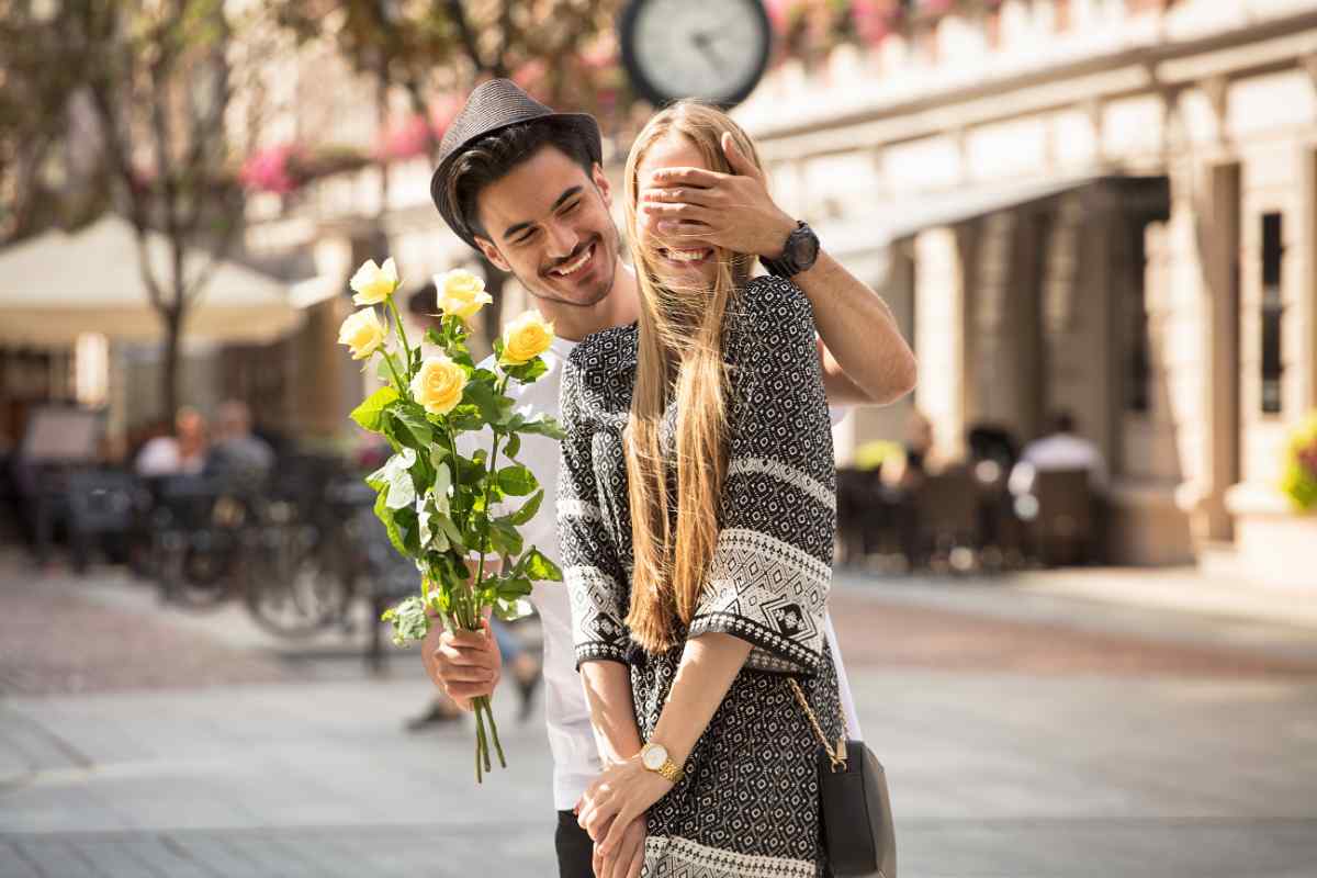Man and woman walking through a garden, speaking in relaxed conversation
