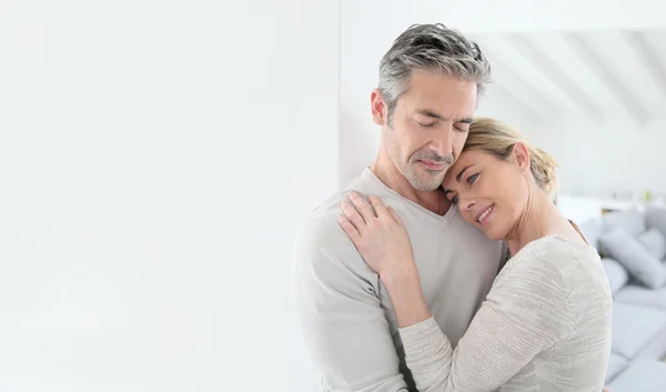 A confident couple looking forward together with energy and purpose, reflecting the shared drive of Aries Sun and Aquarius Moon