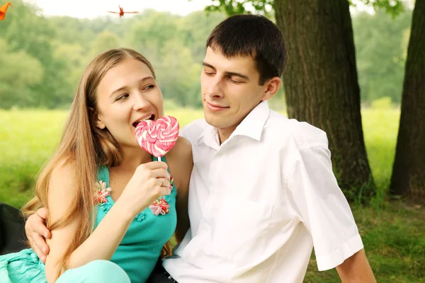 A couple sharing a warm, animated evening out, both clearly delighted by each other